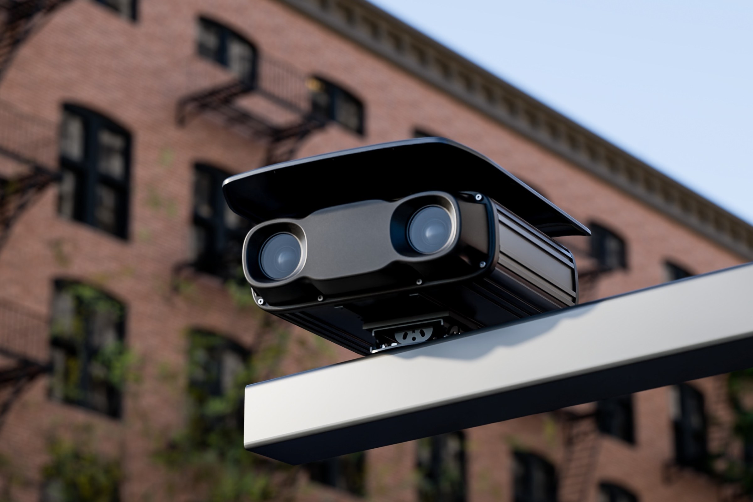 Box Spotter mounted on a street-side arm in front of a brick building