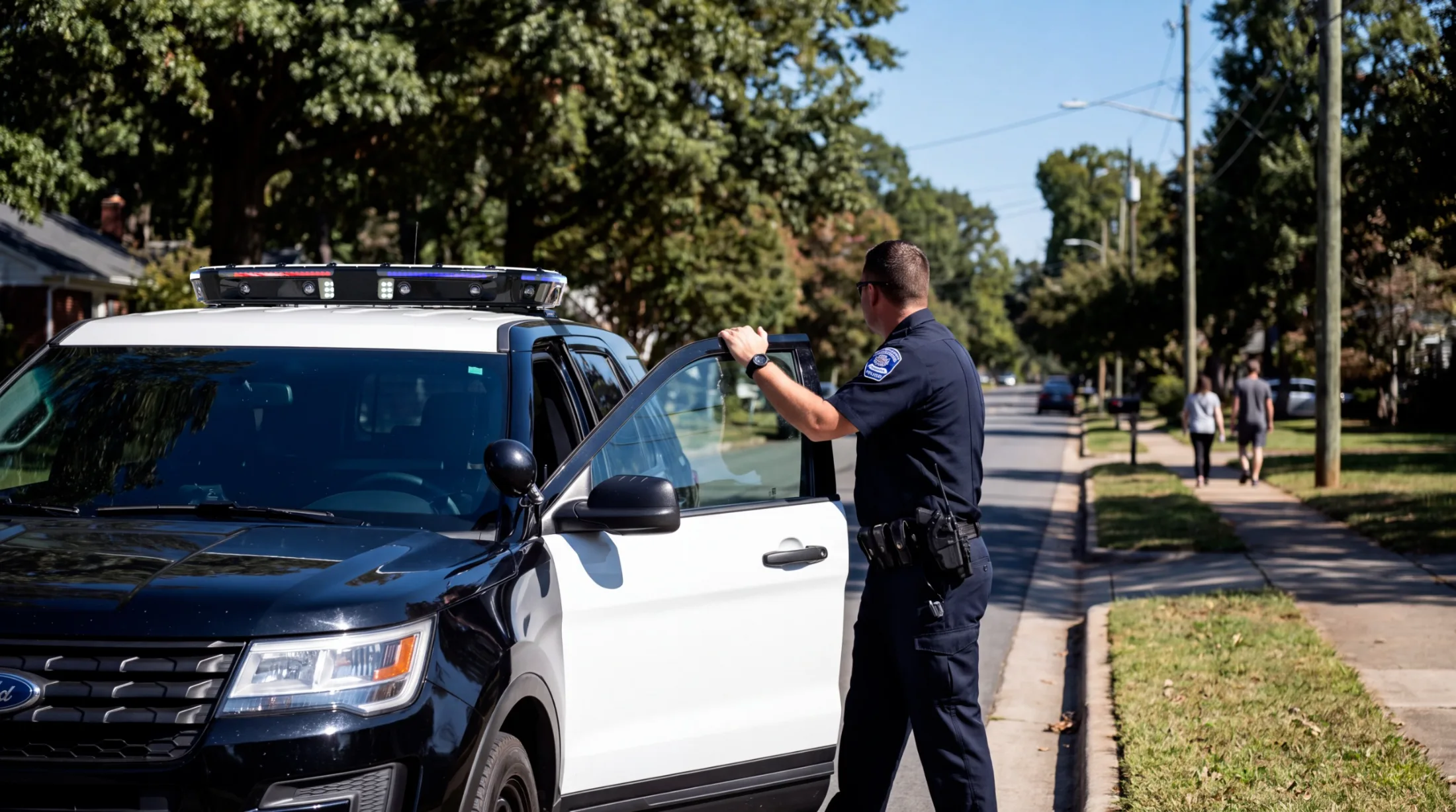 Officer beside a patrol vehicle with Ekin roof-mounted cameras